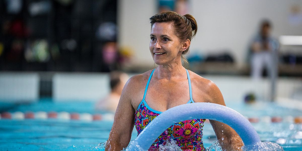 A woman holding onto a flotation noodle during an Aqua fit class at a Christchurch Recreation and Sport pool.