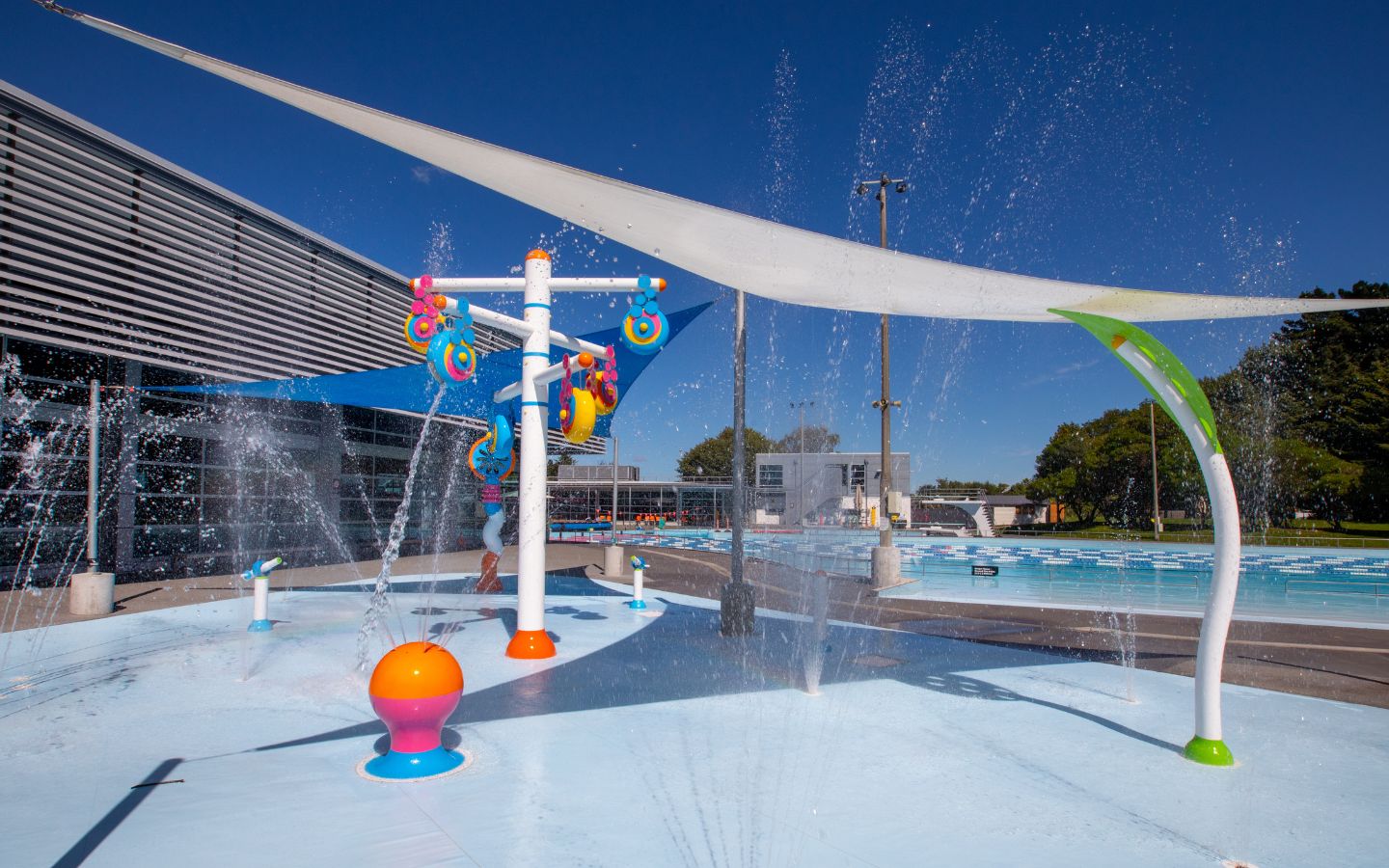 Childrens multicolour splash pad at a Christchurch outdoor summer pool. 