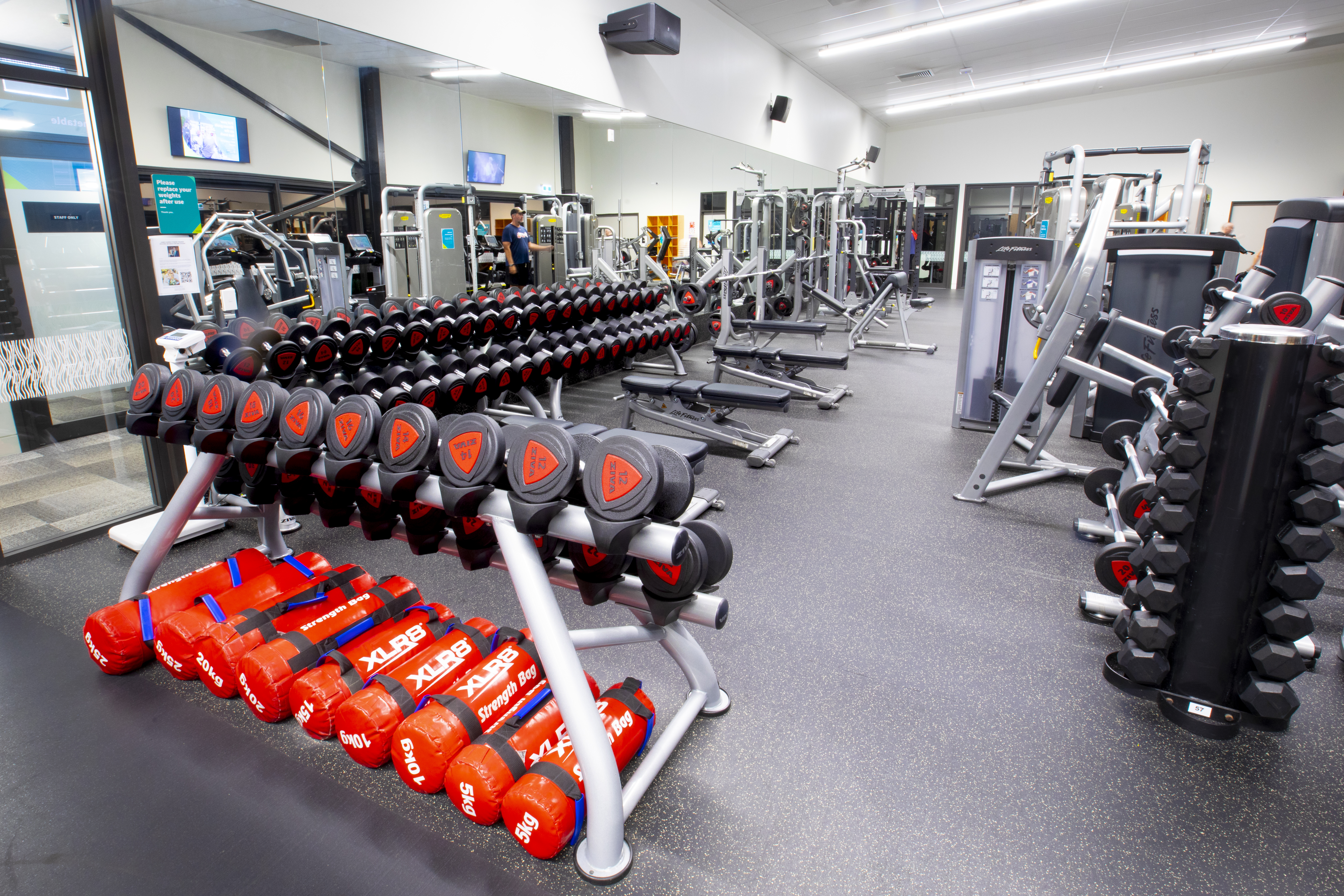 Red and black weight room at Taiora QEII Recreation and Sport centre. 