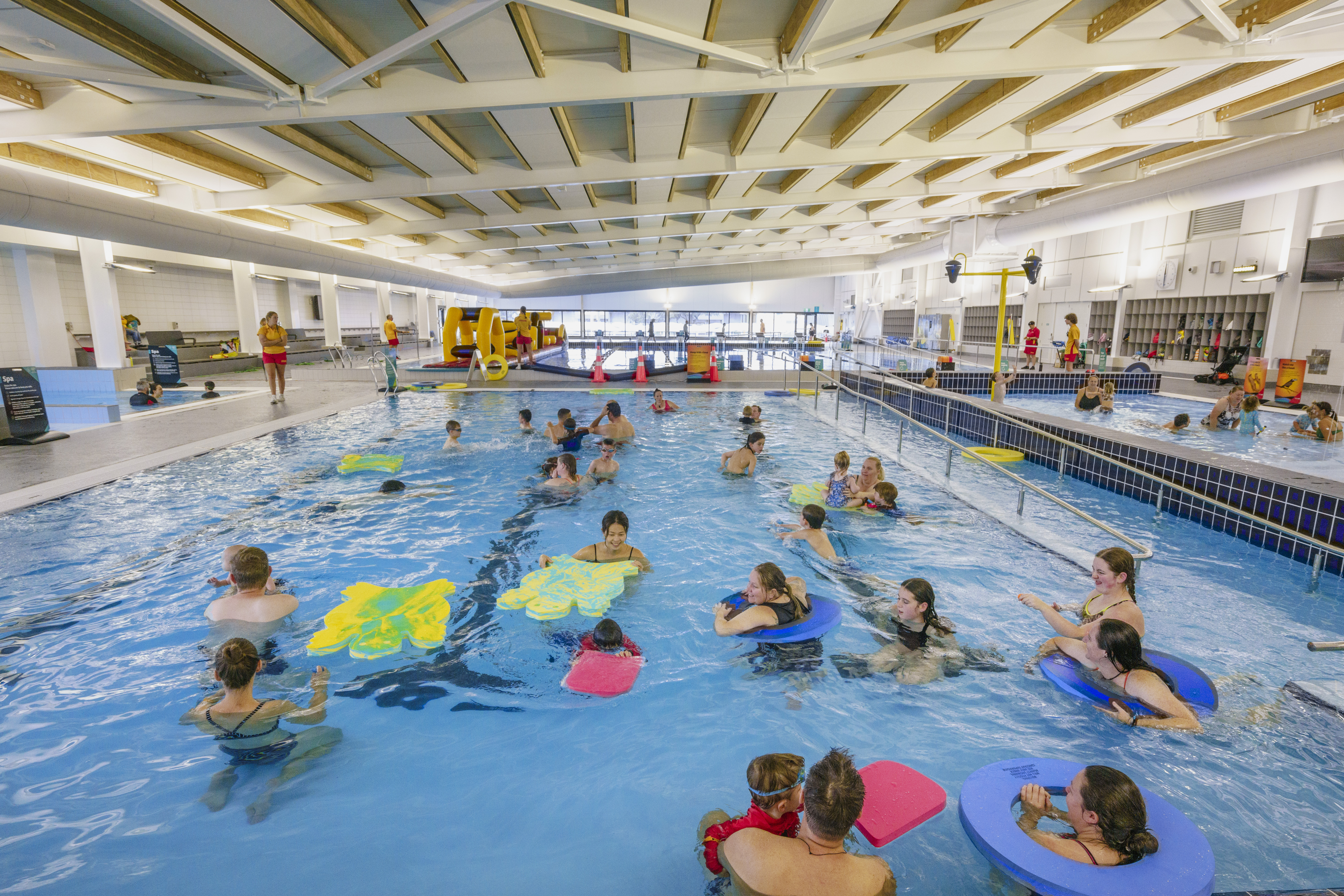 A group of adults and children using the teach pool at Matatiki Hornby centre. 