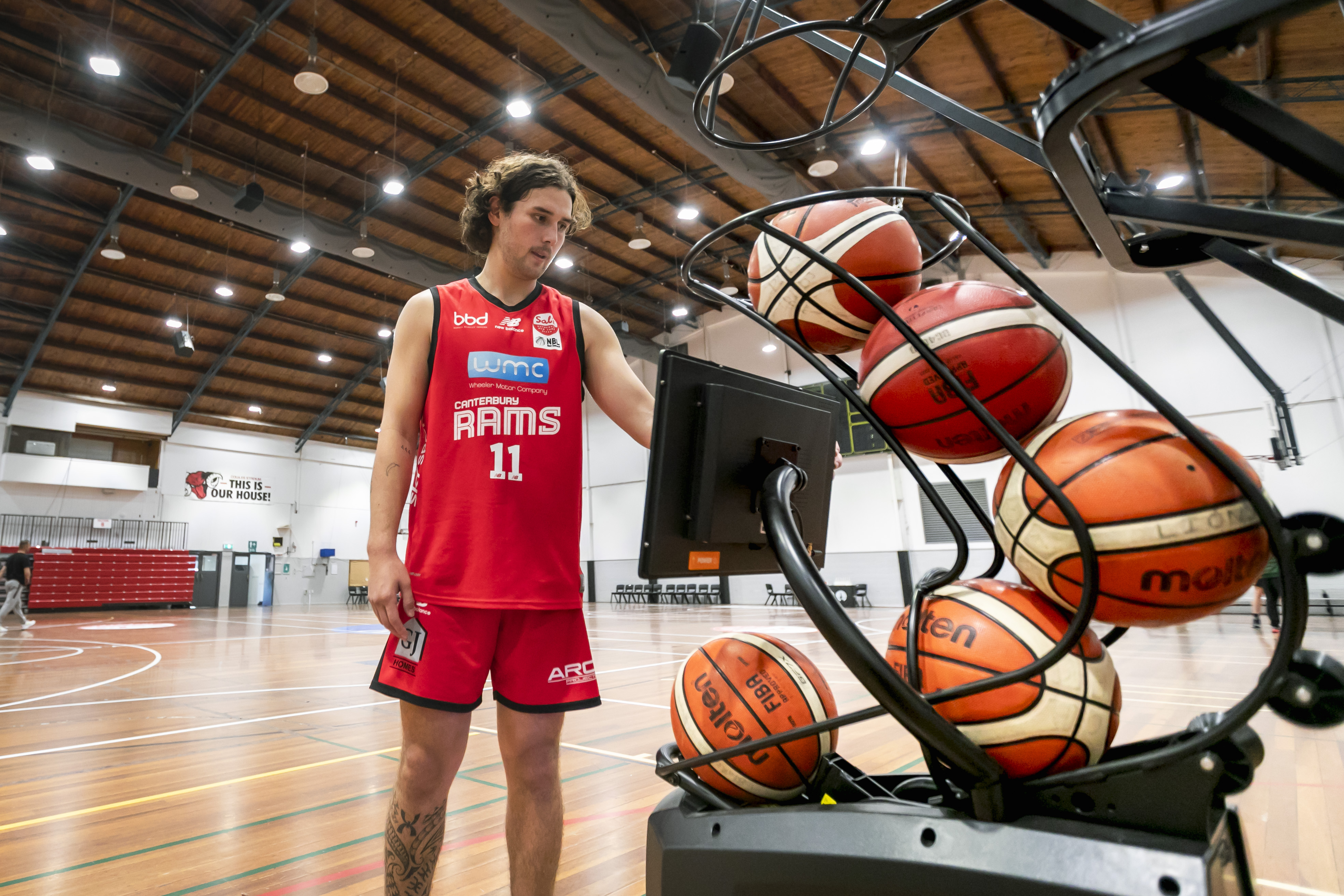 A Canterbury Rams player using a basketball shooting machine at Christchurch Recreation and Sport. 