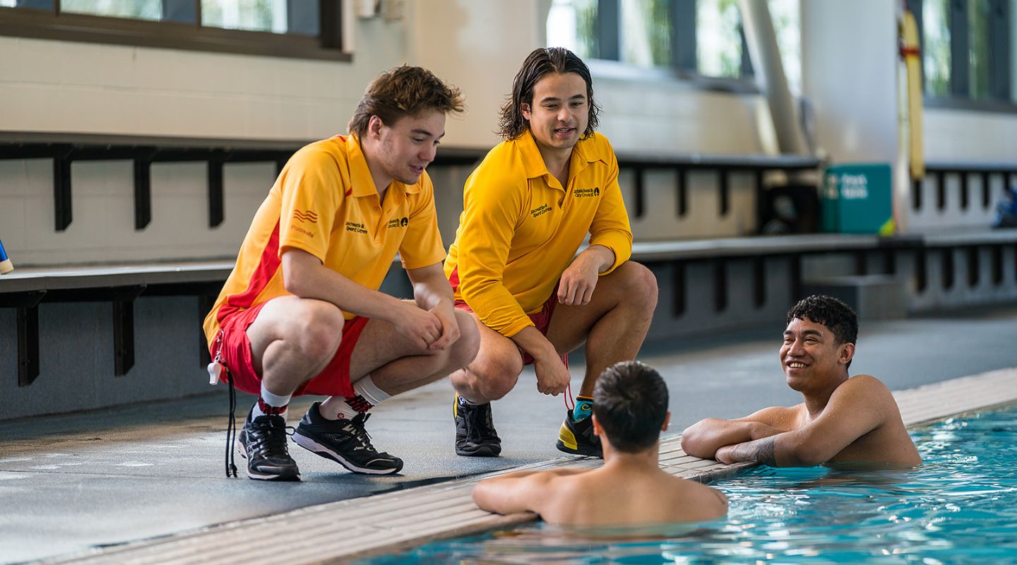 Lifeguards talking to customers in Christchurch swimming pool.